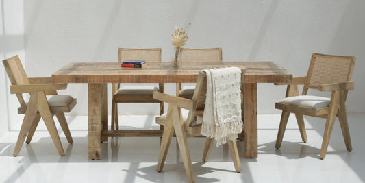 Modern wooden dining table set styled in a contemporary Dubai home interior.