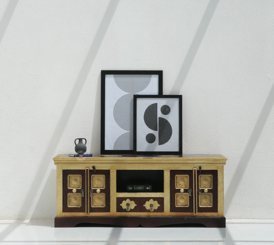 Wooden entertainment console with decorative items against a white wall