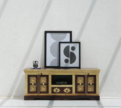 Wooden entertainment console with decorative items against a white wall